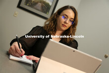 Brenna Lash, a graduate student in the Clinical Psychology Training Program, loads the telehealth pl