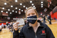 Whitney Steckel shows her vaccine card during Tuesday’s clinic. Vaccine clinic in the Coliseum wit