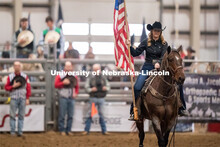 Cowboys lower their hats as the Star-Spangled Banner is performed before the Nebraska Cornhusker Col