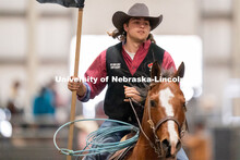 A member of the University of Nebraska rodeo team takes a lap around the track before the Nebraska C