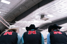 Members of the University of Nebraska rodeo team watches barrel racing event at the Nebraska Cornhus