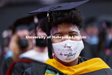 Kristina Bayton wears a mask that describes the challenges of the past year and a half. Graduate Com