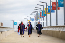 Claudia Brock, Sarah O’Neill and Rachel Lowe walk across the pedestrian bridge toward Pinnacle Ban