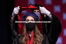 Emily Coffey eyes the prize as her doctoral hood is lowered over her head. College of Law Graduation