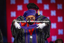 Mauricio Murga Rios receives his hood during College of Law Graduation at Pinnacle Bank Arena. May 7