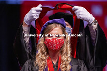 Allison Seiler sports a legal mask as she is hooded. College of Law Graduation at Pinnacle Bank Aren