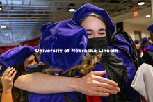 Emily Coffey hugs a classmate after the ceremony. College of Law Graduation at Pinnacle Bank Arena. 
