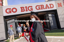 Macy Behrens flashes the peace sign at the UNL Commencement in Memorial Stadium. May 8, 2021. 