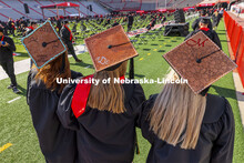 CASNR graduates Jacque Stauffer, Abby Durheim and McCyla Mickelson wore leather tooled mortar board 