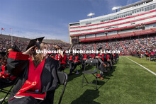 Maddalynne Armstrong waves to family and friends during the ceremony. UNL Commencement in Memorial S