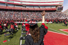 Karlie Sines waves to family and friends after receiving her Fine and Performing Arts degree. UNL Co