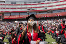 Destiney Chitrodom waves at the UNL Commencement in Memorial Stadium. May 8, 2021. 