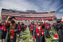 Alissa Clarke and Destiney Chitrodom turn their tassels at the end of the commencement. UNL Commence