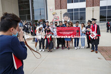 Frederick Chua poses with family and friends after the morning commencement. UNL Commencement in Mem