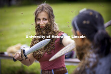 Two bearded foes stage a mock battle as Courtney Wallner and Earl Agpawa face off wearing their bee 
