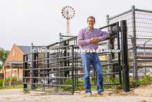 Bryar Gerlach, a senior animal science major, poses by a corral for an ASEM recruitment feature stor