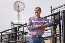Bryar Gerlach, a senior animal science major, poses by a corral for an ASEM recruitment feature stor
