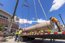 A column’s shaft is lowered onto a trailer outside East Stadium. The columns outside of Memorial S