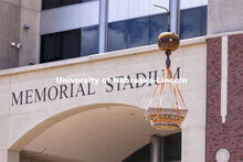 A column’s capital swings over towards its storage. The columns outside of Memorial Stadium are be