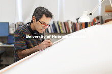 Francisco Souto works on a commissioned artwork in his Richards Hall studio. His intricate drawing w