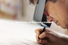 Francisco Souto works on a commissioned artwork in his Richards Hall studio. His intricate drawing w