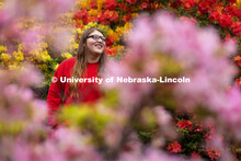 Daelyn Zagurski, a senior fisheries and wildlife major, poses amongst the azaleas on East Campus for