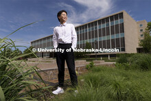 Zhaozhou Dai, a senior journalism major, poses outside of Andersen Hall for an ASEM recruiting story