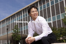 Zhaozhou Dai, a senior journalism major, poses outside of Andersen Hall for an ASEM recruiting story