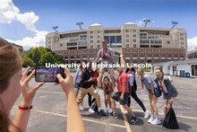 NSE Orientation Leader Gracie Williams takes her group’s photo outside of Memorial Stadium as they