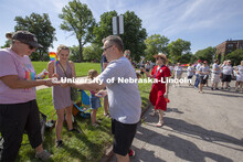 Chancellor Ronnie Green and his wife, Jane, hand out Husker Pride stickers along the Star City Pride