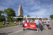 The Husker Pride group walks the parade route around the Nebraska State Capitol on June 19. Thousand
