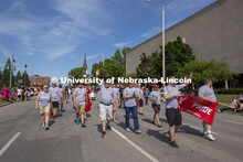 Corrie Svehla waves to the crowd as the Husker Pride entry walks down K Street during the June 19 pa