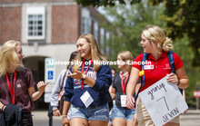 Orientation leader, Peyton Taylor talks with her group of students as they walk to lunch at Cather P