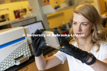 Graduate student Kari Heck places samples into a flow Cytometry analyzer in the Morrison Center for 