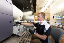 Flow Cytometry Service Center Manager, Dirk Anderson works with samples in a flow Cytometry sorter i