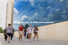 Blue skies and clouds are reflected in the windows of the College of Business’s Hawks Hall as the 