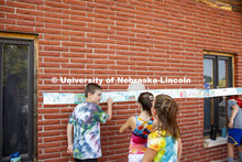 Elementary school campers at Adventure Art Camp pose for a picture in front of their artwork at Ceda