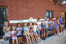 Elementary school campers at Adventure Art Camp pose for a picture in front of their artwork at Ceda