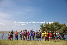 Campers at Adventure Art Camp pose for a picture with their newly painted walking sticks at Cedar Po