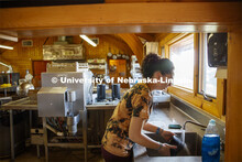 Hailey Showalter, a junior Hospitality Restaurant and Tourism Management major rinses dishes after t