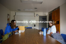 Sarah Hawkinson (blue shirt) and Kaylen Michaelis (tank top) discuss the first few chapters of “O 