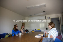 Sarah Hawkinson (blue shirt) and Kaylen Michaelis (tank top) discuss the first few chapters of “O 