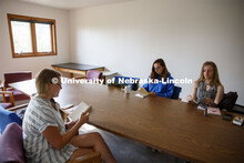 Sarah Hawkinson (blue shirt) and Kaylen Michaelis (tank top) discuss the first few chapters of “O 