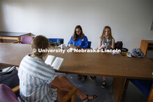 Sarah Hawkinson (blue shirt) and Kaylen Michaelis (tank top) discuss the first few chapters of “O 