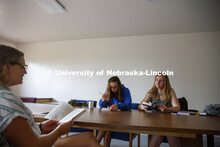 Sarah Hawkinson (blue shirt) and Kaylen Michaelis (tank top) discuss the first few chapters of “O 