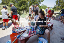 Young campers at Adventure Art Camp paint walking sticks at Cedar Point Station near Lake Ogallala. 