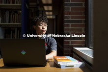 Daniel Nguyen, McNair scholar and senior in psychology, studies in Love Library. July 28, 2021. 