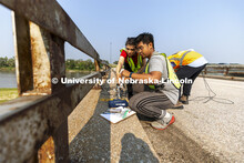 Mitra Nasimi and Awg Ku Ahmad Hashim Bin connect a replacement cable for the bridge sensors before t