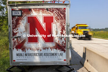 A Nebraska Department of Transportation truck drives past the mobile lab’s equipment trailer. Truc