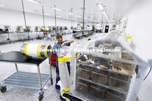 Tammy May, gnotobiotic technician, cleans an interlocking chamber of a mouse isolate in the Nebraska
